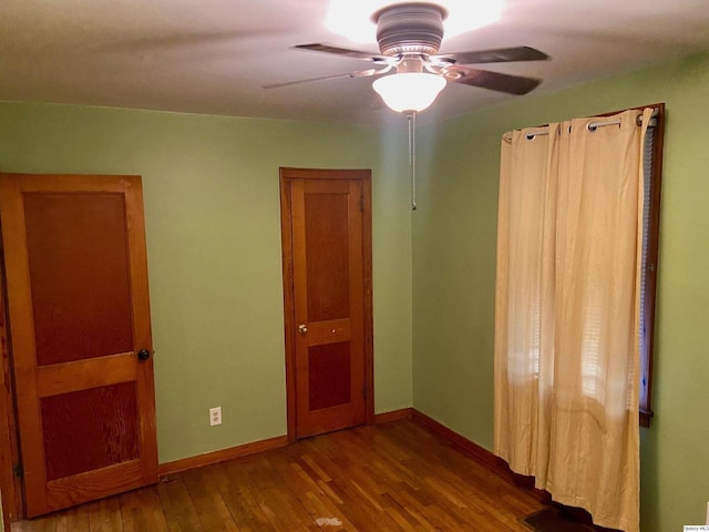 unfurnished bedroom featuring hardwood / wood-style floors and ceiling fan