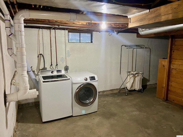 clothes washing area with washing machine and clothes dryer