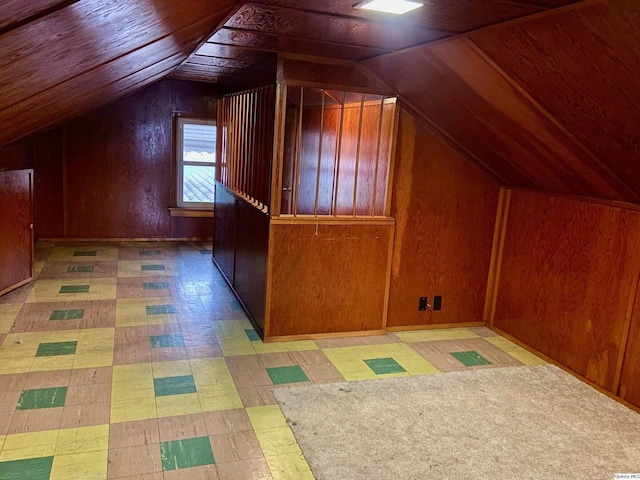 additional living space featuring wooden ceiling, lofted ceiling, and wood walls