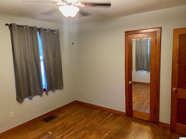 empty room featuring hardwood / wood-style flooring and ceiling fan