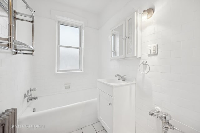 bathroom with vanity, radiator, and tile patterned floors