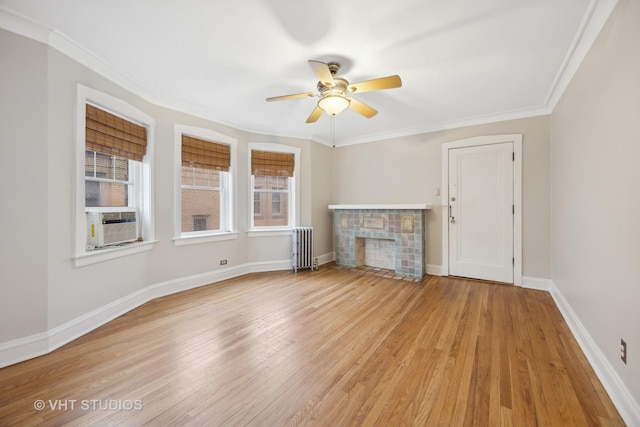 unfurnished living room with radiator, a wealth of natural light, and light wood-type flooring