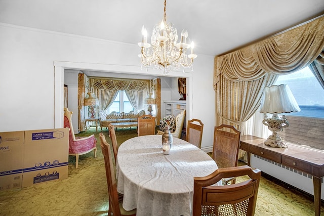 carpeted dining room with radiator and a notable chandelier