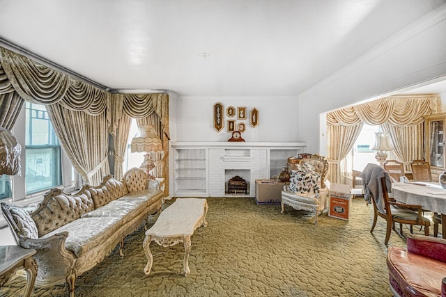 living room featuring a fireplace, carpet, and crown molding