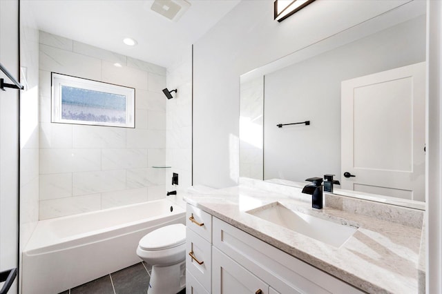 full bathroom featuring tile patterned floors, vanity, tiled shower / bath combo, and toilet