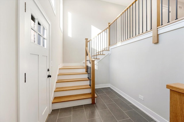 entrance foyer with dark tile patterned flooring