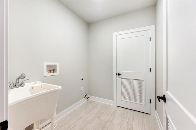 laundry room with hookup for an electric dryer, washer hookup, and sink