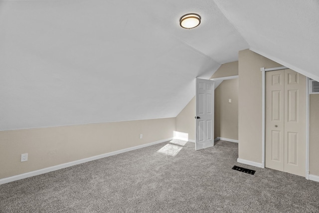 bonus room featuring lofted ceiling and carpet floors