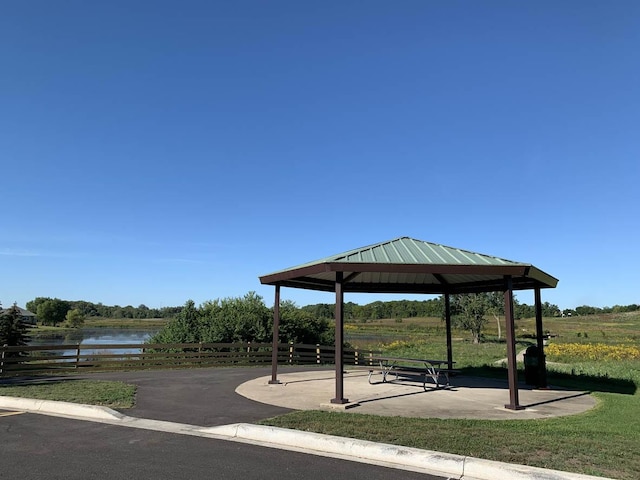 surrounding community with a gazebo and a water view