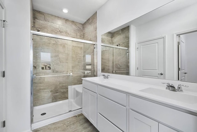 bathroom featuring vanity and an enclosed shower