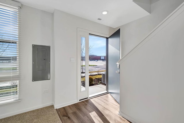 entrance foyer with electric panel and hardwood / wood-style flooring