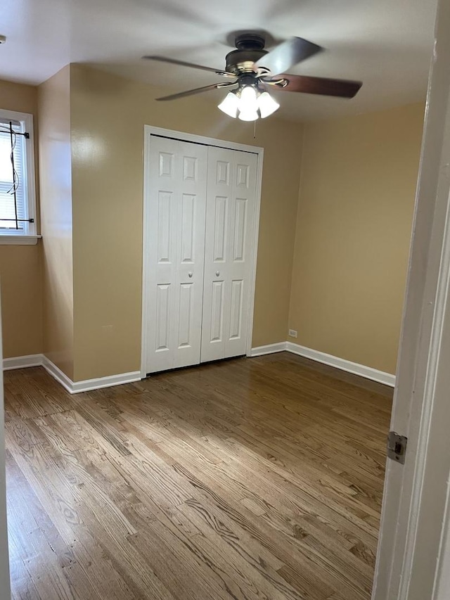 unfurnished bedroom with ceiling fan, a closet, and light hardwood / wood-style flooring