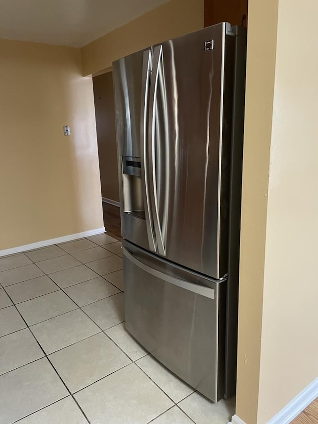 kitchen with stainless steel fridge and light tile patterned flooring