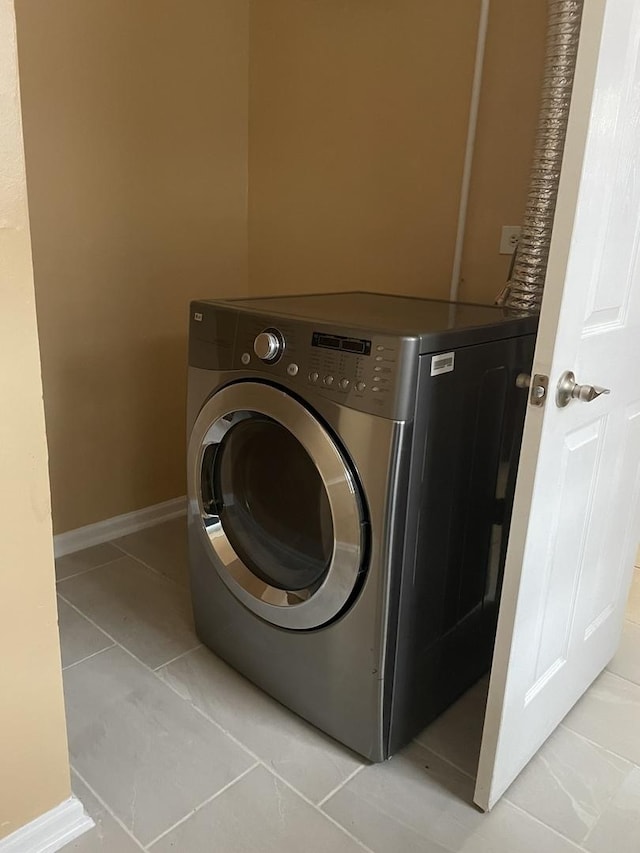 washroom featuring washer / dryer and light tile patterned floors