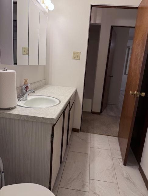 bathroom featuring vanity and toilet