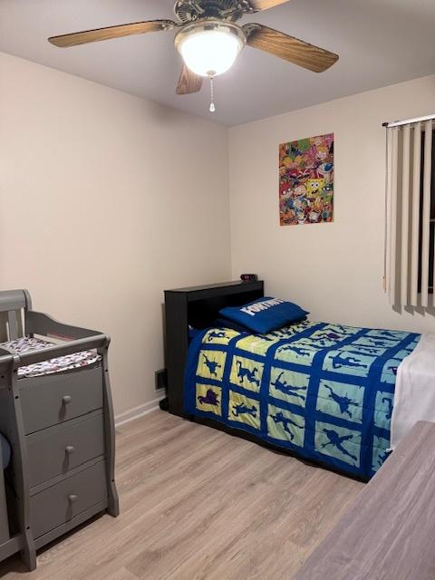 bedroom with ceiling fan and light hardwood / wood-style floors