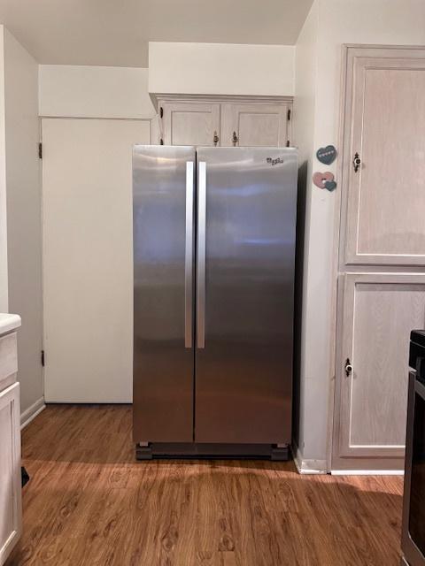 kitchen with stainless steel refrigerator and dark hardwood / wood-style flooring