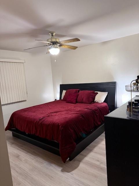 bedroom with ceiling fan and light wood-type flooring