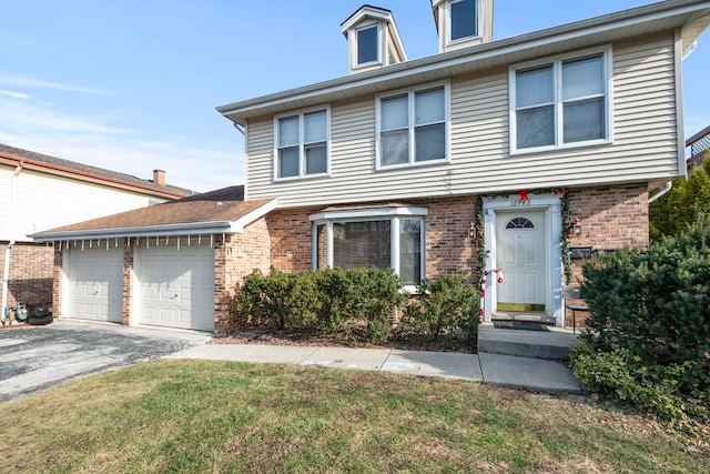 view of front of property featuring a front yard and a garage