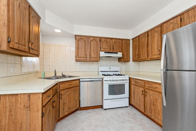 kitchen with decorative backsplash, stainless steel appliances, and sink