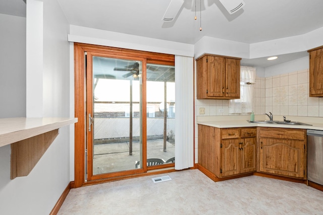 kitchen with dishwasher, tasteful backsplash, ceiling fan, and sink