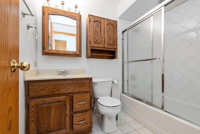 full bathroom featuring tile patterned floors, toilet, combined bath / shower with glass door, and vanity