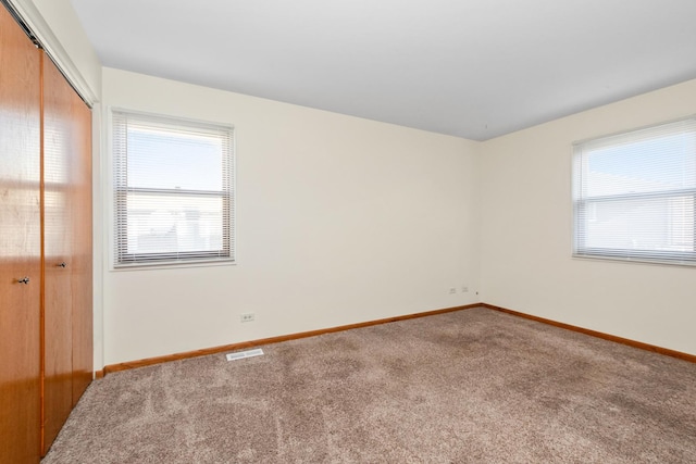 unfurnished bedroom with carpet floors and a closet