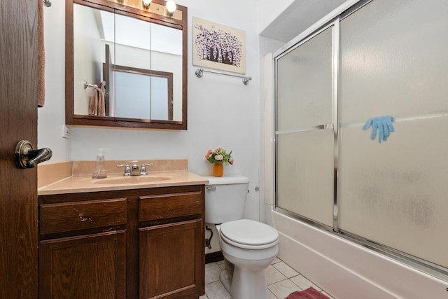 full bathroom featuring toilet, tile patterned flooring, vanity, and combined bath / shower with glass door