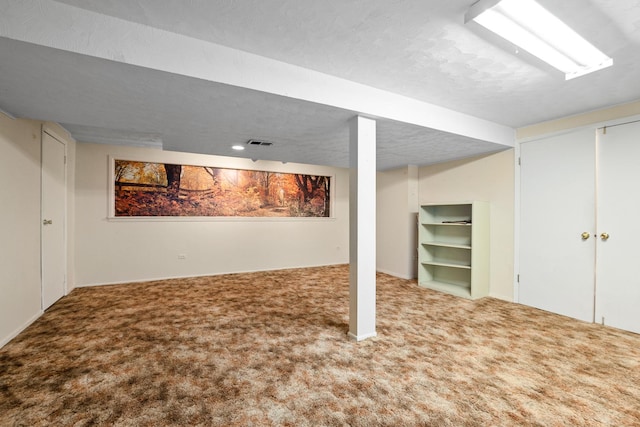 basement with carpet and a textured ceiling