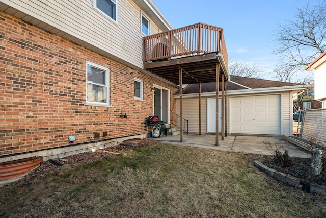 view of side of home with a garage, a balcony, and a yard