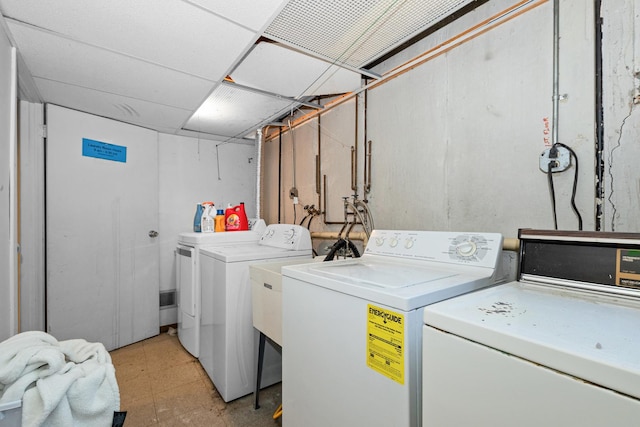 clothes washing area featuring washer and clothes dryer