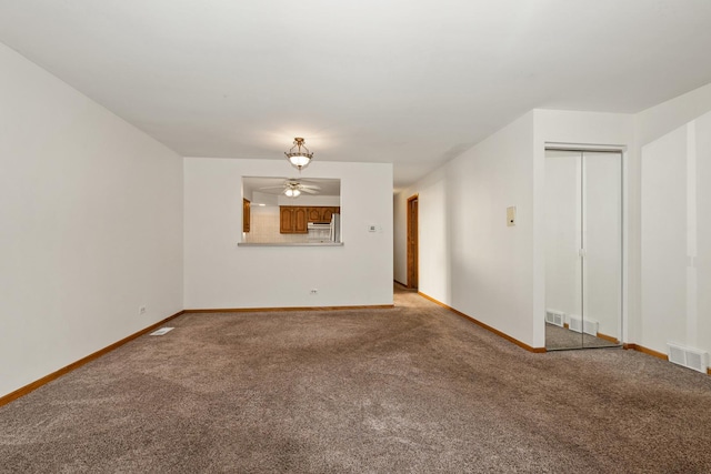 unfurnished living room featuring ceiling fan and light colored carpet