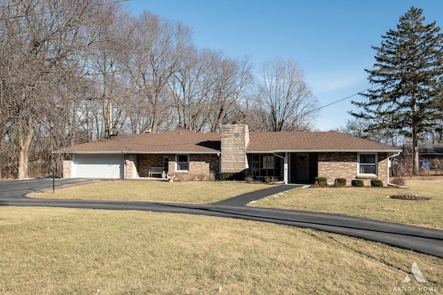 ranch-style home with a garage and a front yard