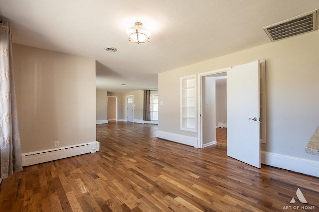 spare room featuring a baseboard radiator, dark wood-type flooring, and built in features