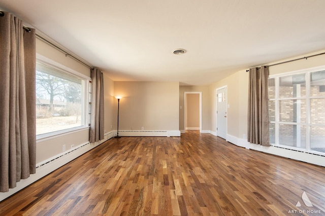 empty room featuring a baseboard radiator and hardwood / wood-style floors