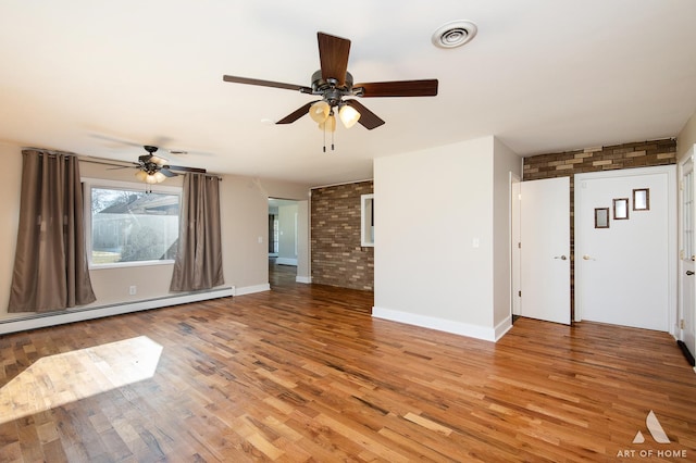 unfurnished living room with brick wall, light wood-type flooring, and baseboard heating