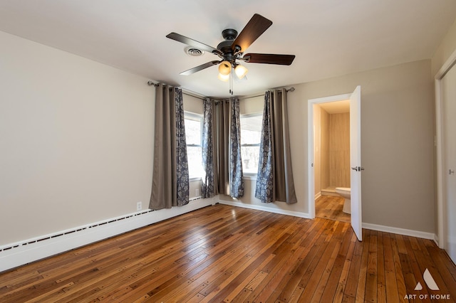 spare room featuring wood-type flooring, ceiling fan, and a baseboard radiator