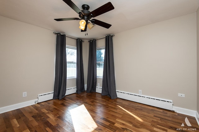 empty room with ceiling fan, a baseboard heating unit, and dark hardwood / wood-style flooring