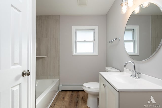 bathroom featuring vanity, plenty of natural light, a baseboard heating unit, and a bath