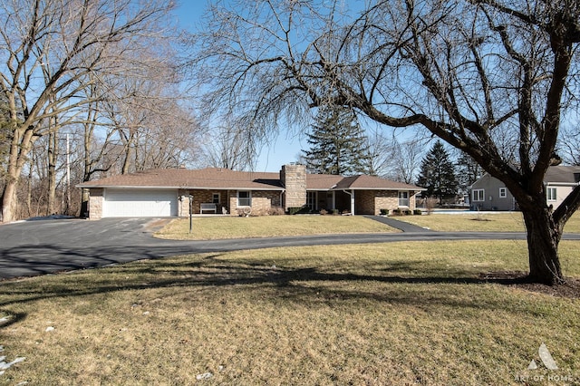 single story home featuring a garage and a front yard