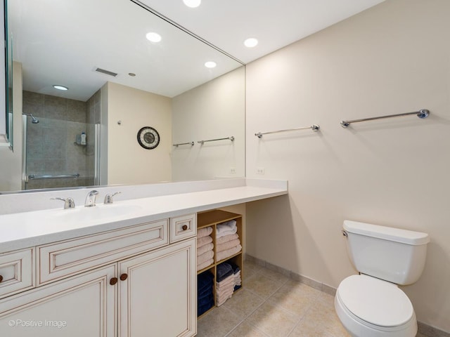 bathroom featuring tile patterned flooring, vanity, toilet, and an enclosed shower