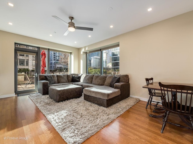 living room featuring hardwood / wood-style floors and ceiling fan