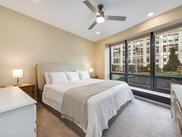 bedroom featuring ceiling fan, carpet floors, and baseboard heating