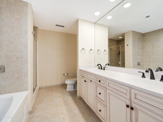 full bathroom with plus walk in shower, vanity, tile patterned floors, and toilet