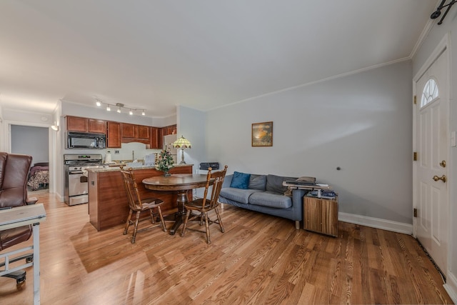 living room with crown molding and light hardwood / wood-style flooring