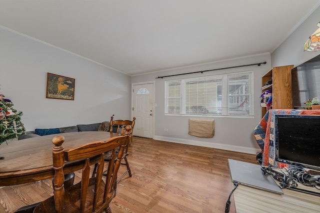 dining space featuring light hardwood / wood-style floors and ornamental molding