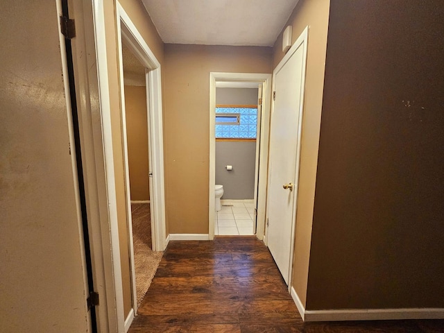 corridor featuring dark hardwood / wood-style flooring