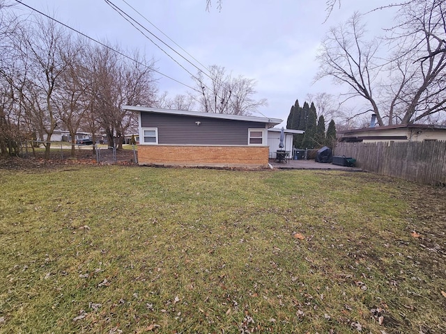 rear view of house featuring a yard and a patio