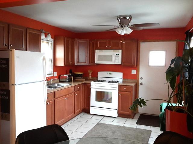 kitchen with ceiling fan, sink, light tile patterned floors, and white appliances