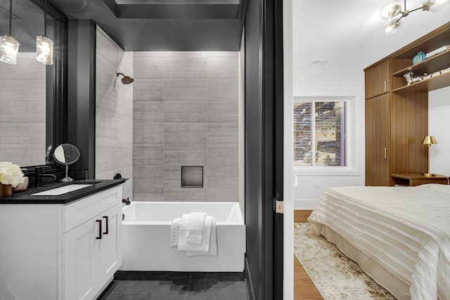 bathroom featuring vanity, visible vents, wood finished floors, and bathing tub / shower combination